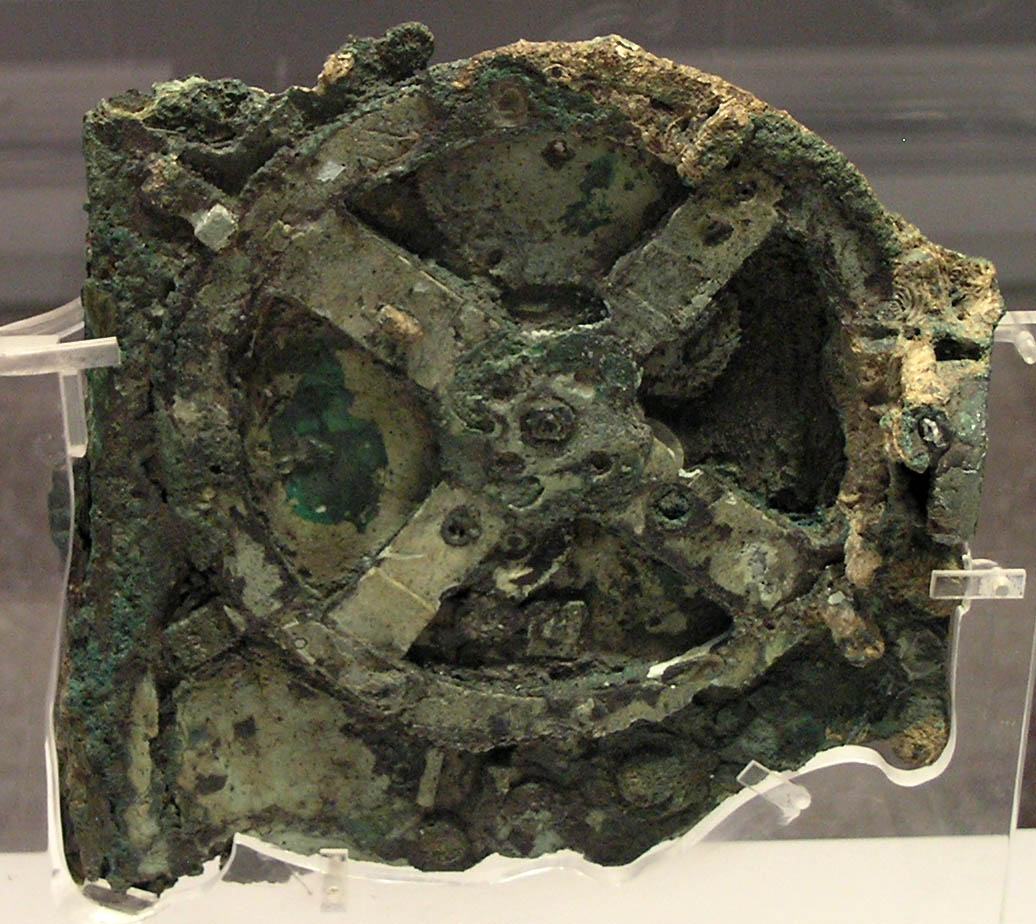 The largest surviving fragment of the Antikythera mechanism, corroded bronze gearwork in a museum case