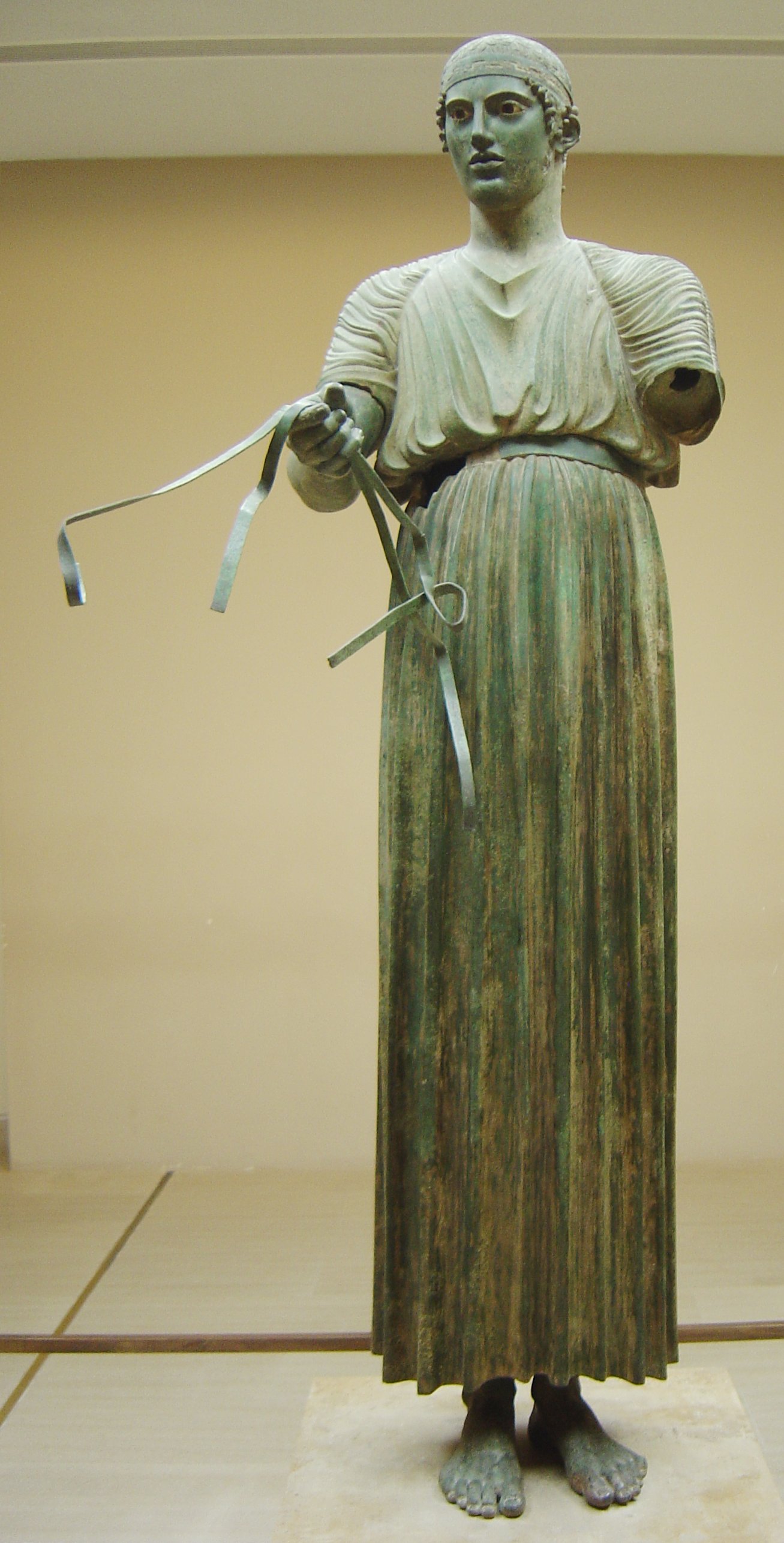 The bronze Charioteer of Delphi, shown complete from crown to feet, reins in hand